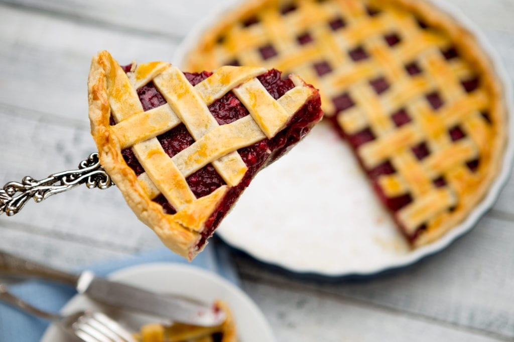 A berry pie with one slice being lifted by a server, illustrating how you can sell a portion of your mortgage note and keep the rest