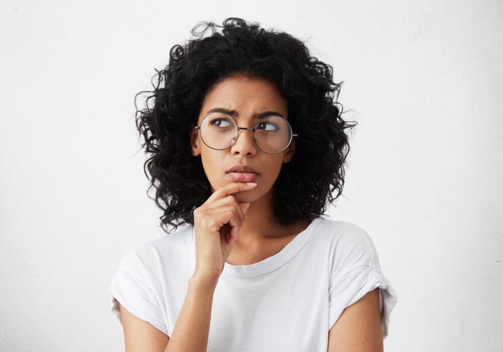 Woman thinking through whether to choose a full mortgage note sale or a partial sale