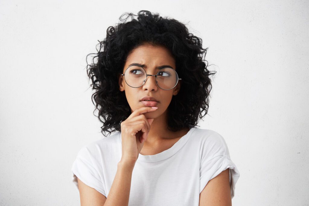 Woman thinking through a full sale versus partial mortgage note sale decision