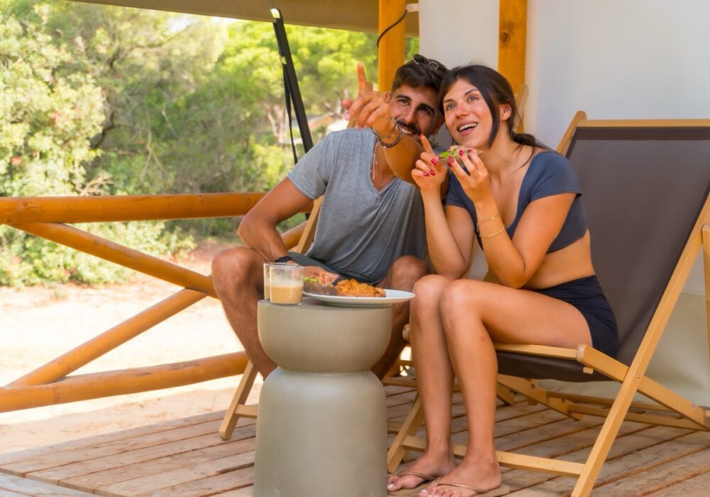 couple relaxing outdoors on a deck exploring options for selling an owner-financed note in 2026