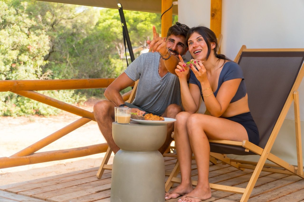 couple relaxing outdoors on a deck exploring options for selling an owner-financed note in 2026